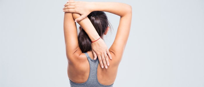person doing overhead arm stretches
