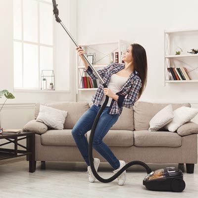 Woman lifting her vacuum cleaner