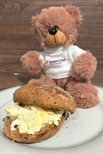 PT the bear eating scrambled egg sandwich as a healthy breakfast.