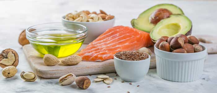 table of healthy fish, nuts fruit and oils