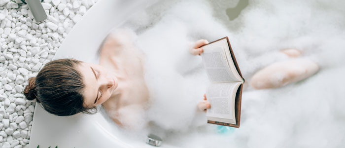 woman reading in the bath