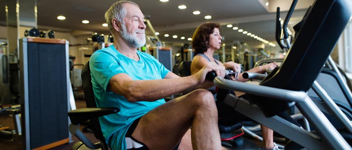 elderly people on recumbent bikes at the gym
