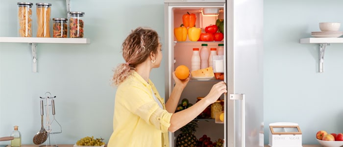 woman in the fridge getting some fruit