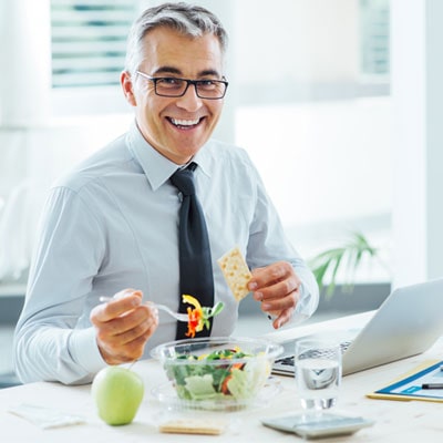 Man eating healthily at work
