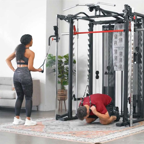 two people working out on a functional trainer
